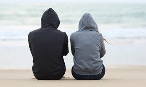 Two young people looking out to sea